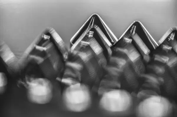 stock image Close-up macro of sewing studs arranged in symmetrical rows in black and white abstraction