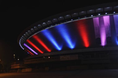 Illuminated in red and blue, the Spodek in Katowice, Poland clipart