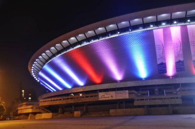 Illuminated in red and blue, the Spodek in Katowice, Poland clipart