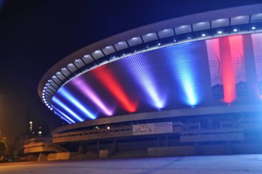 Illuminated in red and blue, the Spodek in Katowice, Poland clipart