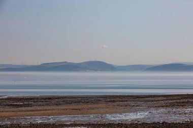 Looking out over Swansea Bay from Mumbles beach, on a misty summer's morning