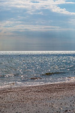 The sunlight shimmering on the ocean, at Camber Sands in East Sussex