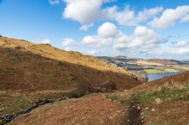 Looking along a pathway in the Lake DIstrict with a view of Ullswater in the distance