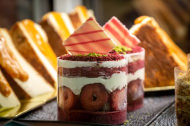 A close up of pretty berry desserts in a shop window, with selective focus