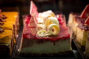 A display of pretty cream cakes in a confectioners window