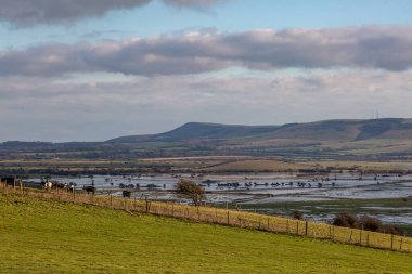 Flooded farmland in the South Downs as seen from a hillside near Lewes, on a January day