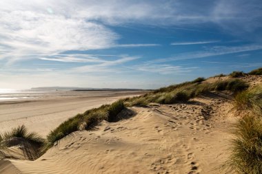 A view over sand dunes, at Camber Sands on the Sussex coast clipart