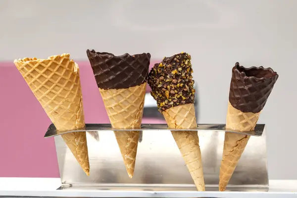 A variety of ce cream cones lined up, with a shallow depth of field