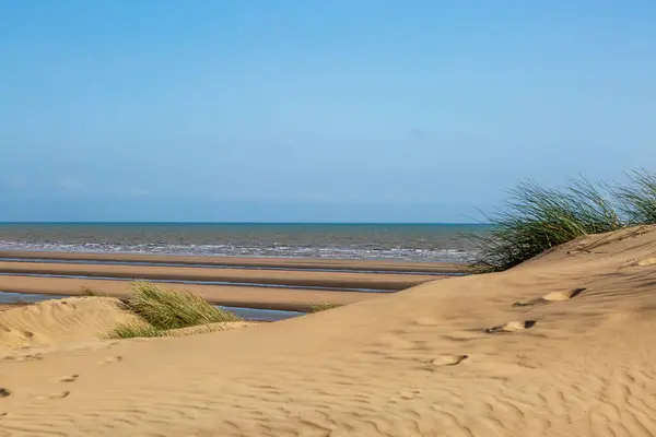 stock image Camber Sands on the Sussex coast, with a blue sky overhead