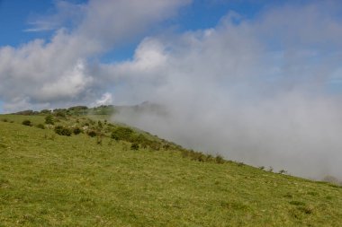 A view over Ditchling Beacon in the South Downs, on a sunny but misty morning clipart