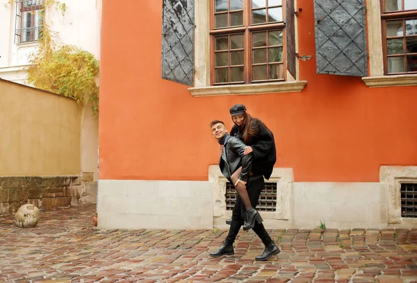 Amazing couple, the guy runs holding his girlfriend on his back. The concept of love and romance, November 2, 2019, Lviv, Ukraine.