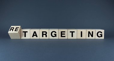 A conceptual image comparing the words TARGETING and RETARGETING on wooden blocks. This visual represents the two key strategies in digital marketing for reaching new and existing customers clipart