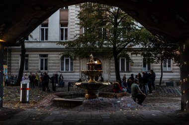 Vienna, Austria - October 16, 2022: Fountain of the Hundertwasserhaus or Hundertwasser house, an apartment house designed by the artist Friedensreich Hundertwasser with people around in Landstrabe district, Vienna, Austria 