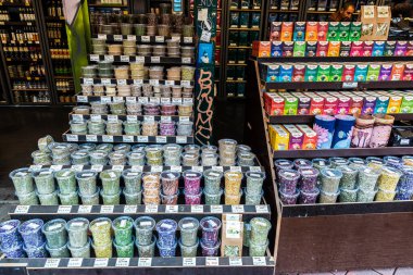 Vienna, Austria - October 14, 2022: Vendor in a spice, tea and flavor shop in Naschmarkt, street food market in Vienna, Austria