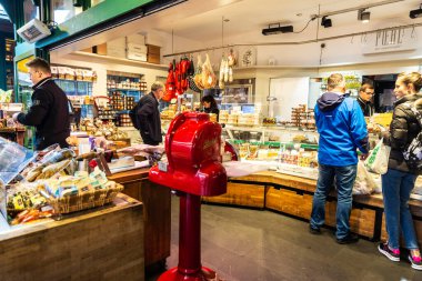 Vienna, Austria - October 14, 2022: Delicatessen shop in Naschmarkt, street food market with people around in Vienna, Austria