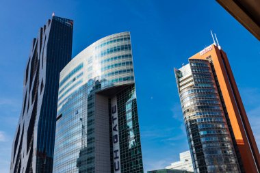 Vienna, Austria - October 17, 2022: Facade and sign of the office building of PWC, Unisyx and Tech Gate Vienna, modern skyscrapers in Donau City or Vienna DC, Vienna, Austria