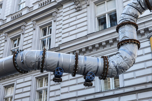Winding pipe to drain water with valves on a street in Vienna, Austria