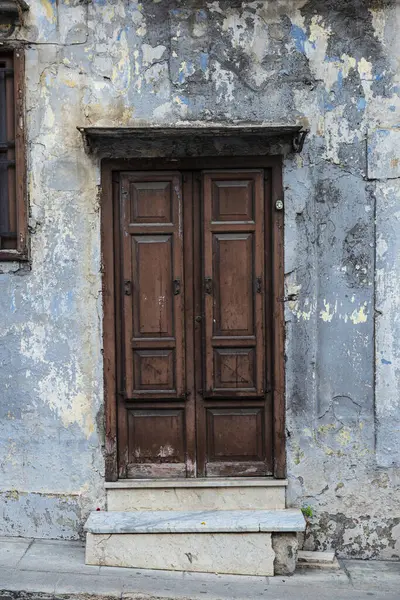 Old wood door on a street of the old town of Monreale, Palermo, Sicily, Italy