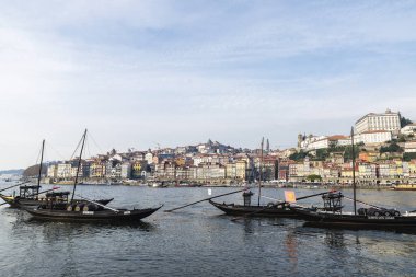 Oporto, Portekiz - 24 Kasım 2023: Oporto veya Portekiz 'de Rabelo adlı kargo botlarıyla Douro nehri boyunca uzanan Ribeira bölgesinin görüntüsü