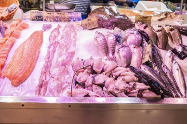 Fresh fish, turbot, red mullet, salmon, black bream, red porgy and monkfish tail in a fish shop in Les Halles Market, street food market in Narbona or Narbonne, Occitanie, France clipart