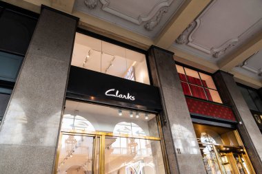 Turin, Italy - November 24, 2024: Sign of a Clarks shoe store on a shopping street in Turin or Torino, Italy clipart