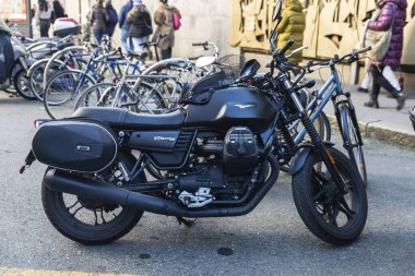 Turin, Italy - November 25, 2024: Guzzi V7 III Stone black motorcycle parked on a street in Turin or Torino, Piedmont, Italy clipart