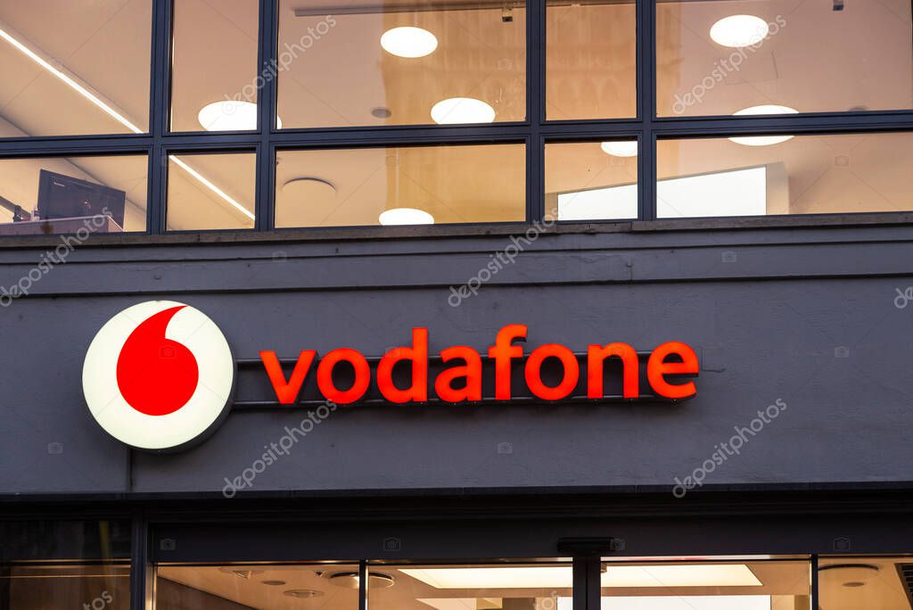Munich, Germany - April 3, 2025: Sign of the Vodafone shop in Kaufingerstrabe, shopping street in Munich, Bavaria, Germany