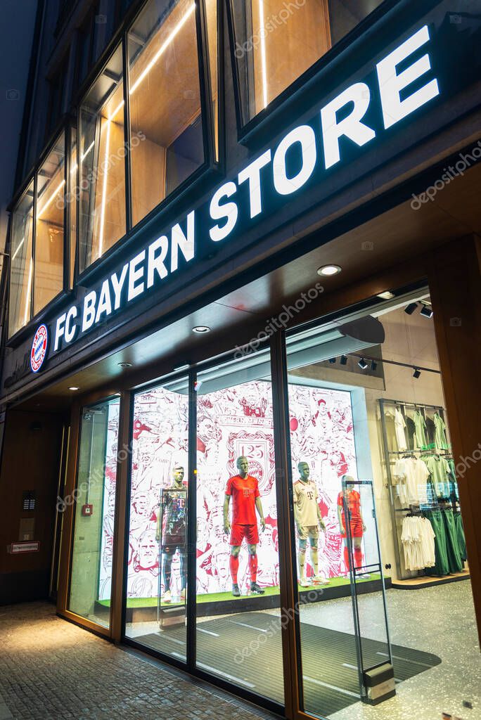 Munich, Germany - April 3, 2025: Display of FC Bayern Munchen store at night in Kaufingerstrabe, a shopping street in Munich, Germany