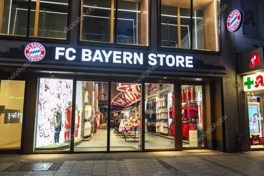 Munich, Germany - April 3, 2025: Display of FC Bayern Munchen store at night in Kaufingerstrabe, a shopping street in Munich, Germany