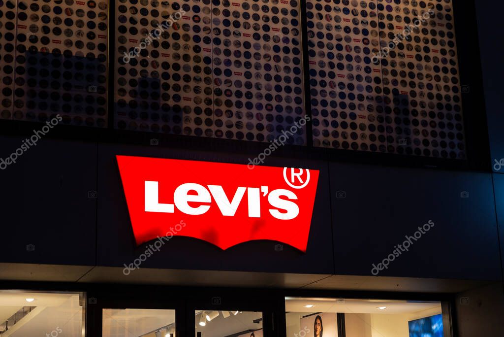 Munich, Germany - April 3, 2025: Sign of a Levis clothing store at night in Kaufingerstrabe, a shopping street in Munich, Germany