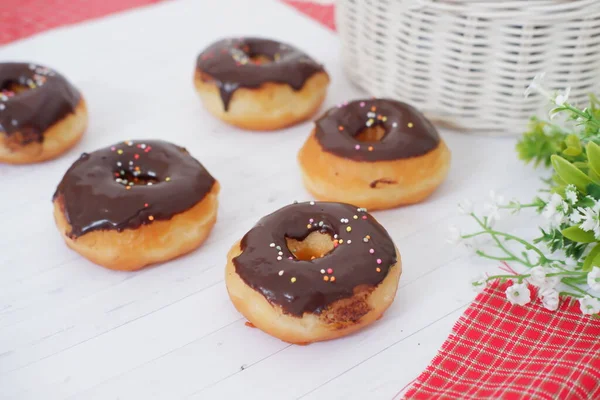 donuts with delicious chocolate coating as a background