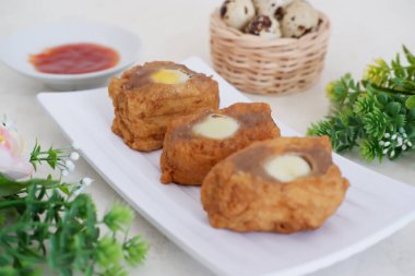 Fried tofu filled with quail eggs