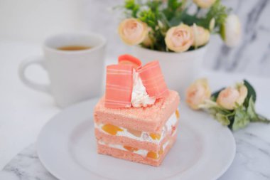 Beyaz arka planda bir parça kek ve çay, stok fotoğrafı.