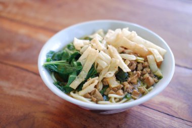 Tahta masada, beyaz kasede kızarmış şehriye.