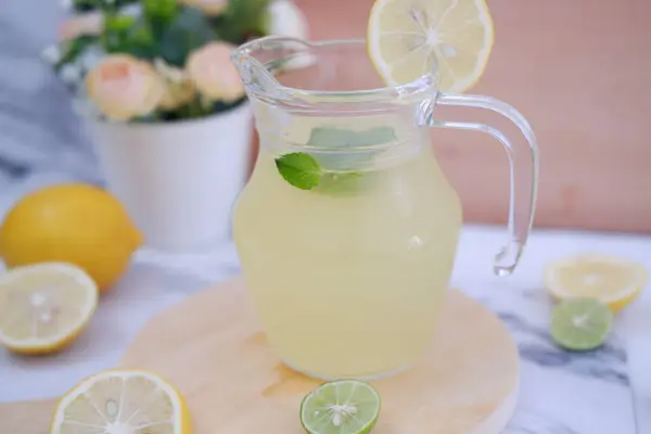 stock image Lemonade with fresh lemon and mint leaves on a white background