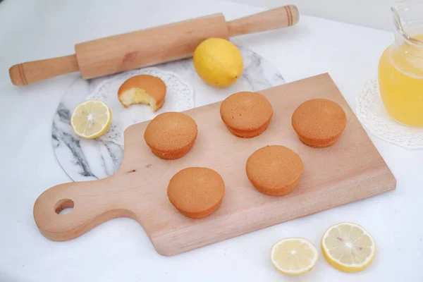 Lemon cake with lemon on wood background. Selective focus.