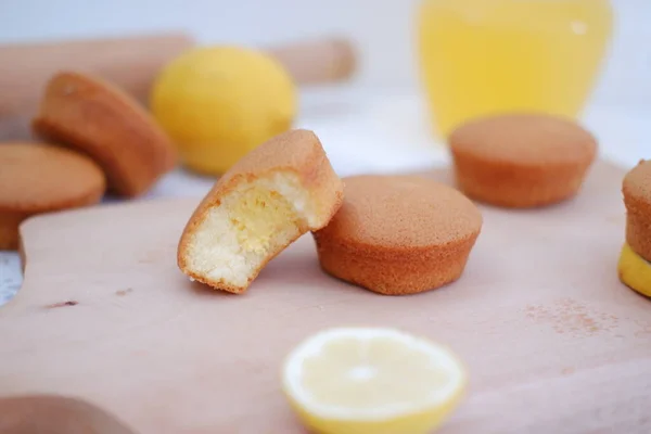 Lemon cake with lemon on wood background. Selective focus.