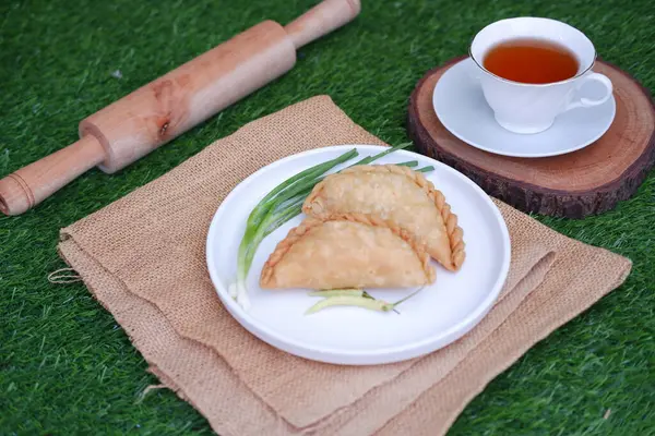 Curry puff or Pastel Goreng is Pastry Popular in Indonesia. fried pastry with filling of sauted vegetable, chicken and boiled egg. accompanied with  sauce or raw chilli pepper