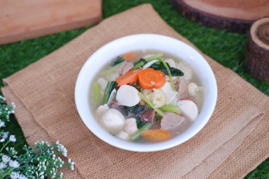 Capcay, kızarmış sebzeleri mantar, köfte ve tavukla karıştır. Beyaz kasede servis edilir.