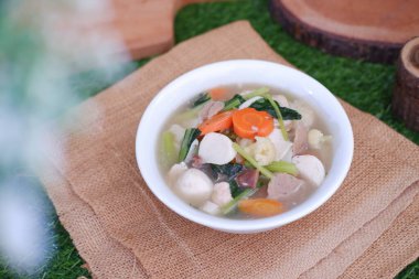 Capcay, kızarmış sebzeleri mantar, köfte ve tavukla karıştır. Beyaz kasede servis edilir.