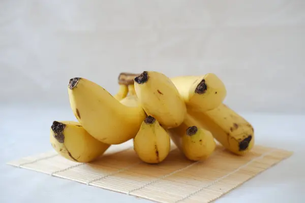 Bunch of bananas on a white marble table. Selective focus.