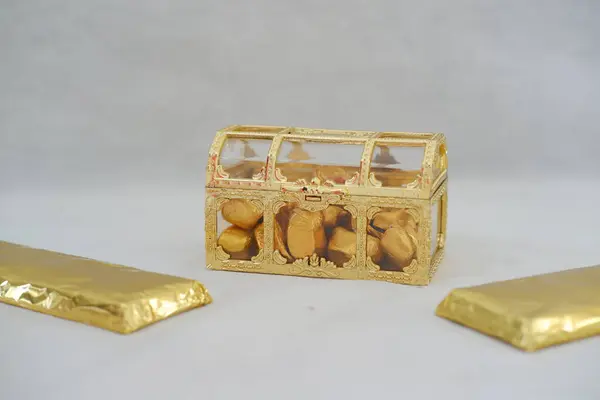 golden box with chocolate and gold chocolate bars on a white background. chinese new year