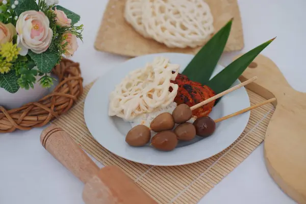 stock image rice with skewered quail eggs and crackers on wood background. Selective focus.