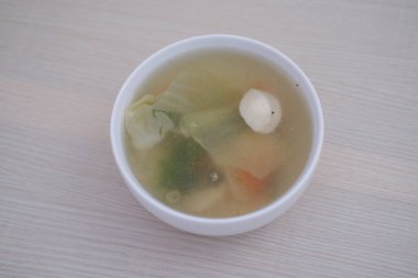 ahşap bir masada çorba bir kase