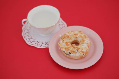 donut and cup on the red table clipart