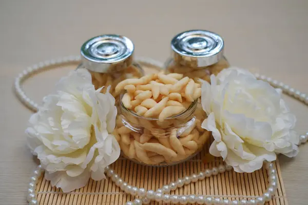 Beyaz çiçekli ve incili zarif abur cubur kavanozu.