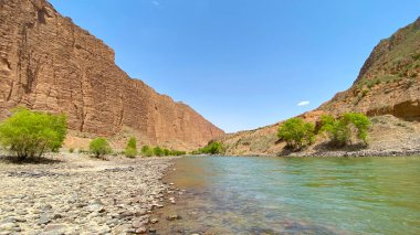 Kırgızistan 'da muhteşem bir kanyonun manzarası. Bir dağ nehri görülebilir. Kaya kıyısı. Kırgızistan 'ın güzel doğası.