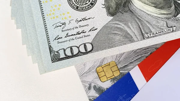 Different credit cards are with $100 bills. The American national currency. Close-up. Cash bills of one hundred US dollars. Financial business background concept.