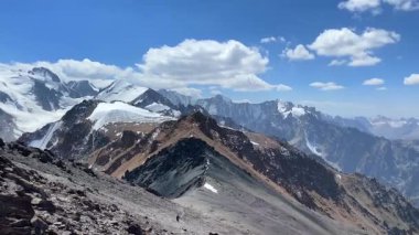 Komsomolets Tepesi 'nin tepesinden büyüleyici bir manzara. Ala-Archa Ulusal Parkı, Kırgızistan. Kırgız sırtının karlı dağları, kayaları, yamaçları ve tepeleri.