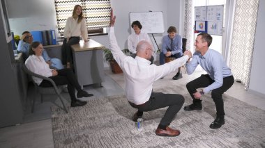 İş adamları güven, denge ve destek oyunu oynuyorlar. Bir kır evinde takım oluşturma etkinliği. Akıl hocasından uzak bir inziva. İş konsepti. Sahne kaygısız ve eğlenceli oldu..